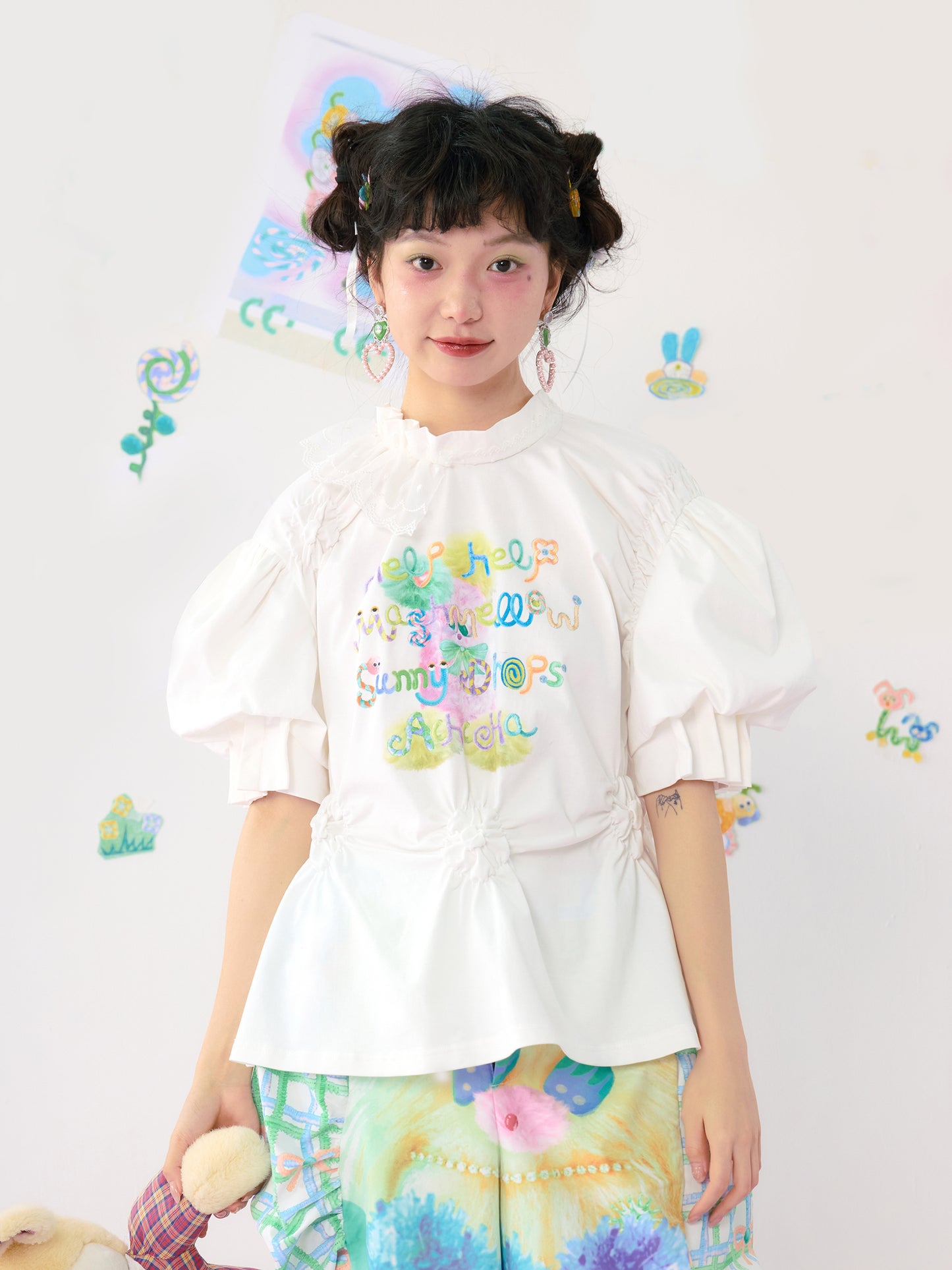 HelpHelp Harajuku style white T-shirt featuring colorful graffiti illustrations, lace trim, and ruched puff sleeves for a playful and artistic look.