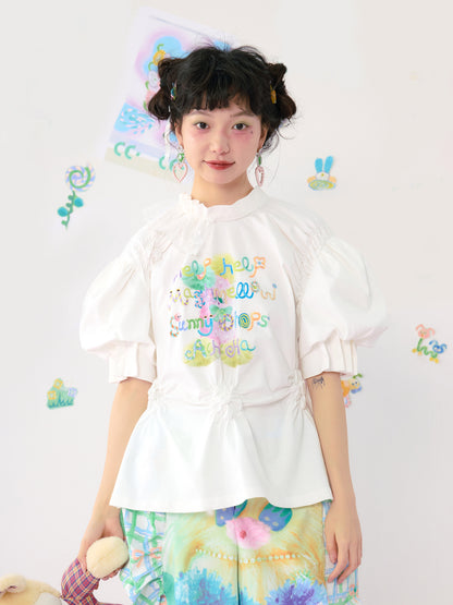 HelpHelp Harajuku style white T-shirt featuring colorful graffiti illustrations, lace trim, and ruched puff sleeves for a playful and artistic look.