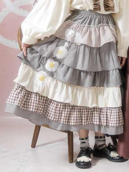 Harajuku Sweet Lolita cake skirt with brown plaid patchwork and egg pouch, featuring a layered ruffle design.