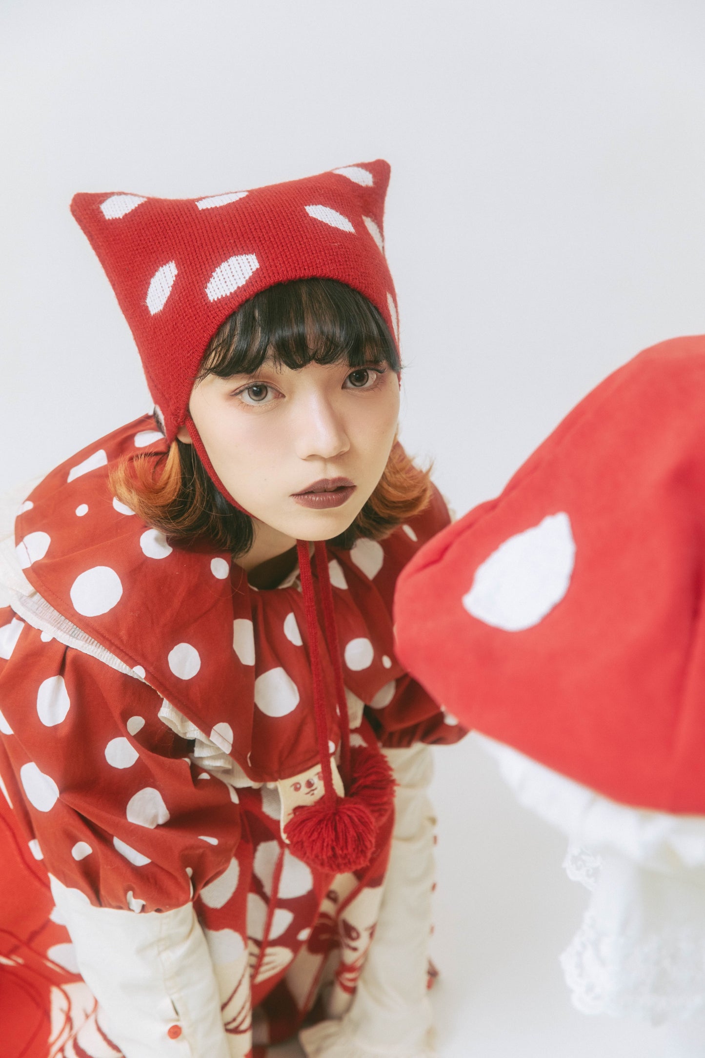 Meugler Niuchou Island Fantasy Circus knitted hat featuring red mushroom polka dots and cute cat ears for a playful, whimsical look.